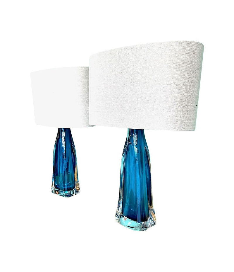 A pair of 1960s Orrefors turquoise glass and brass lamps with new bespoke linen shades