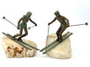 A large pair of bronze cast skiers by Curtis Jere mounted on onyx slabs