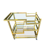 A 1970s Romeo Rega Italian bar trolley with multiple smoked glass shelves