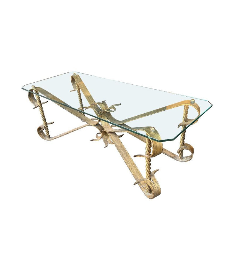 A Spanish 1950s gilt wrought iron coffee table with thick glass top