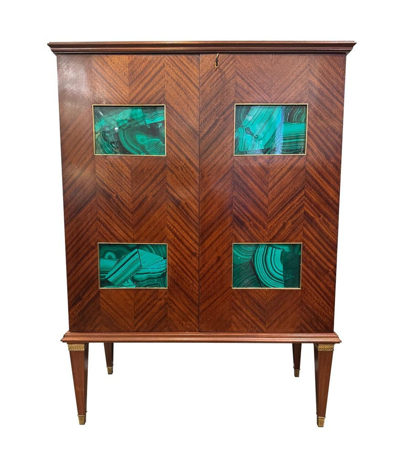 A wonderful 1950s two door bar cabinet by Poalo Buffa with faux malachite panels