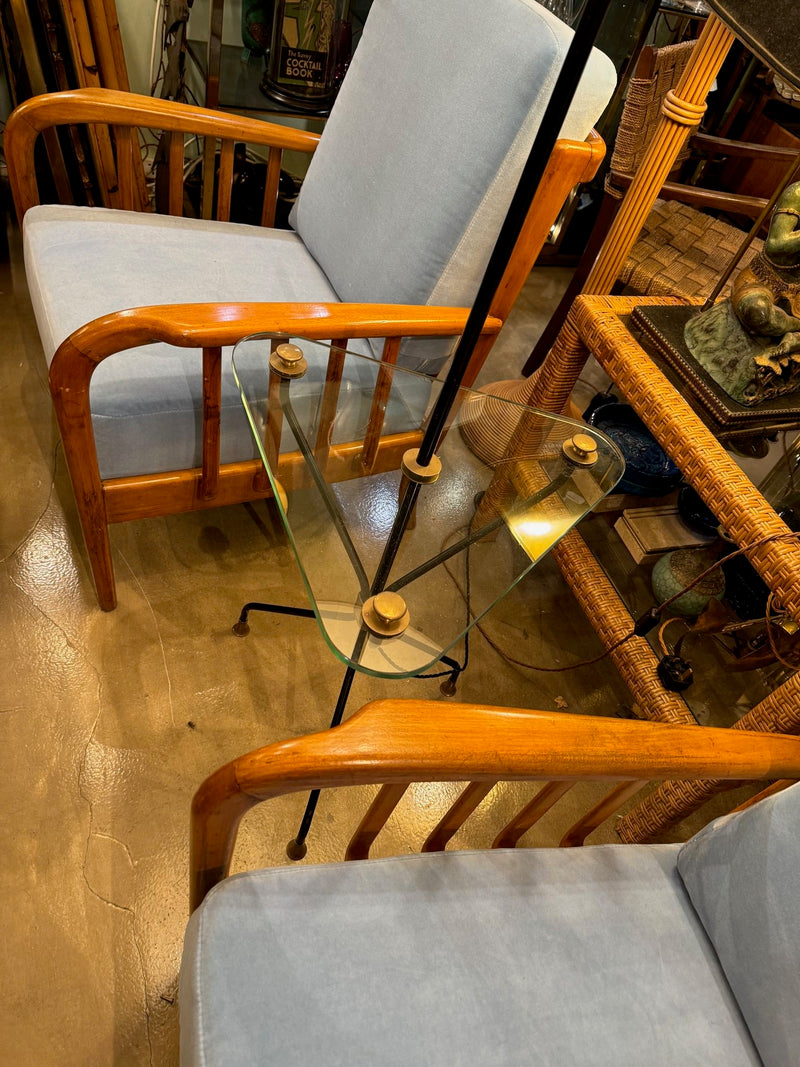 A 1950s French black lacquer and brass tripod floor lamp with glass centre table