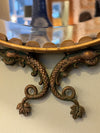 A pair of Italian 1940s oval mirrors with dolphin detailing around the brass frame