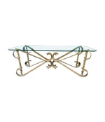 A Spanish 1950s gilt wrought iron coffee table with thick glass top