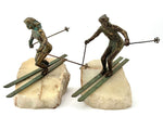 A large pair of bronze cast skiers by Curtis Jere mounted on onyx slabs