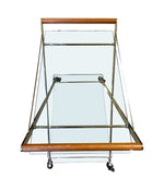 A 1980s Gallotti and Radice “Mister” bar trolley with brass frame and cherry wood handles.