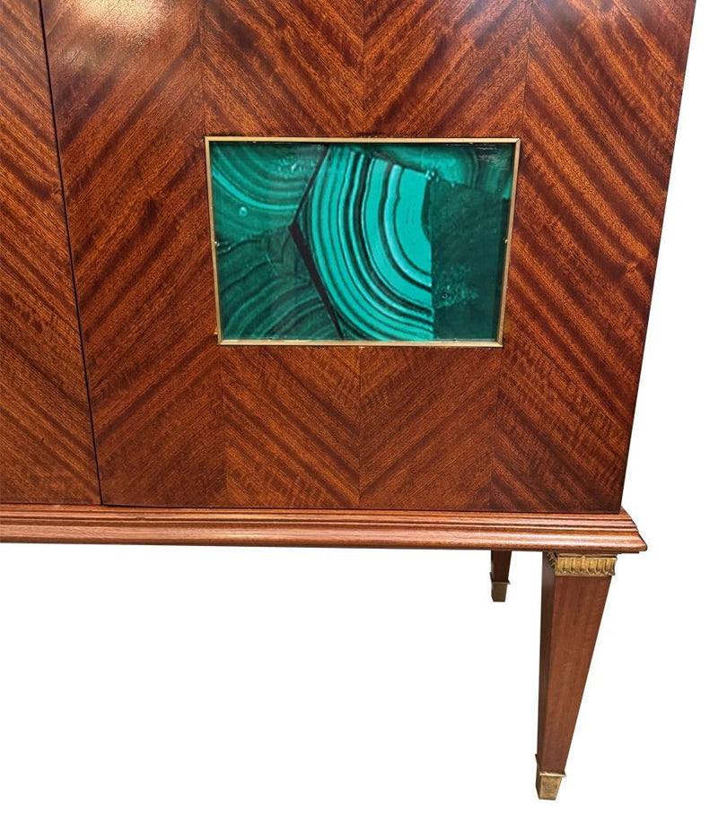 A wonderful 1950s two door bar cabinet by Poalo Buffa with faux malachite panels