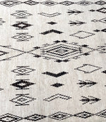 A vintage handwoven Moroccan berber rug, with tribal diamond and line pattern by the Beni Ouarian tribe