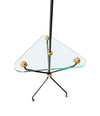 A 1950s French black lacquer and brass tripod floor lamp with glass centre table