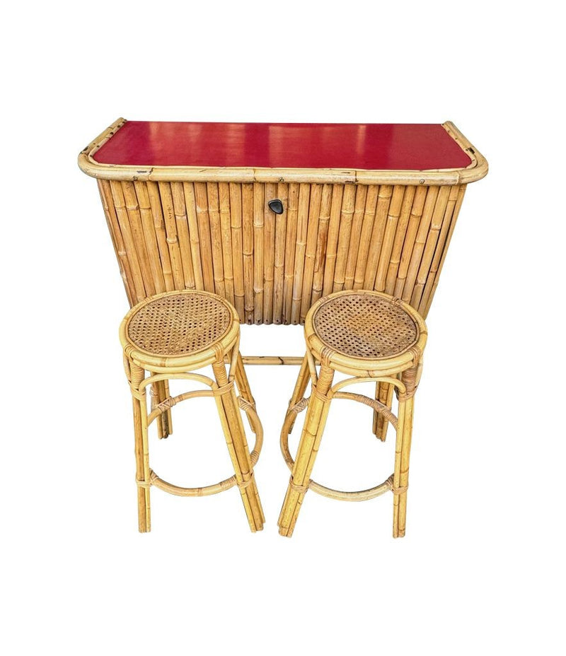 An Italian 1960s bamboo bar cabinet with red laminate top and two stools