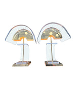 A large unusual pair of 1980s lucite and brass lamps with curved lucite shade and base