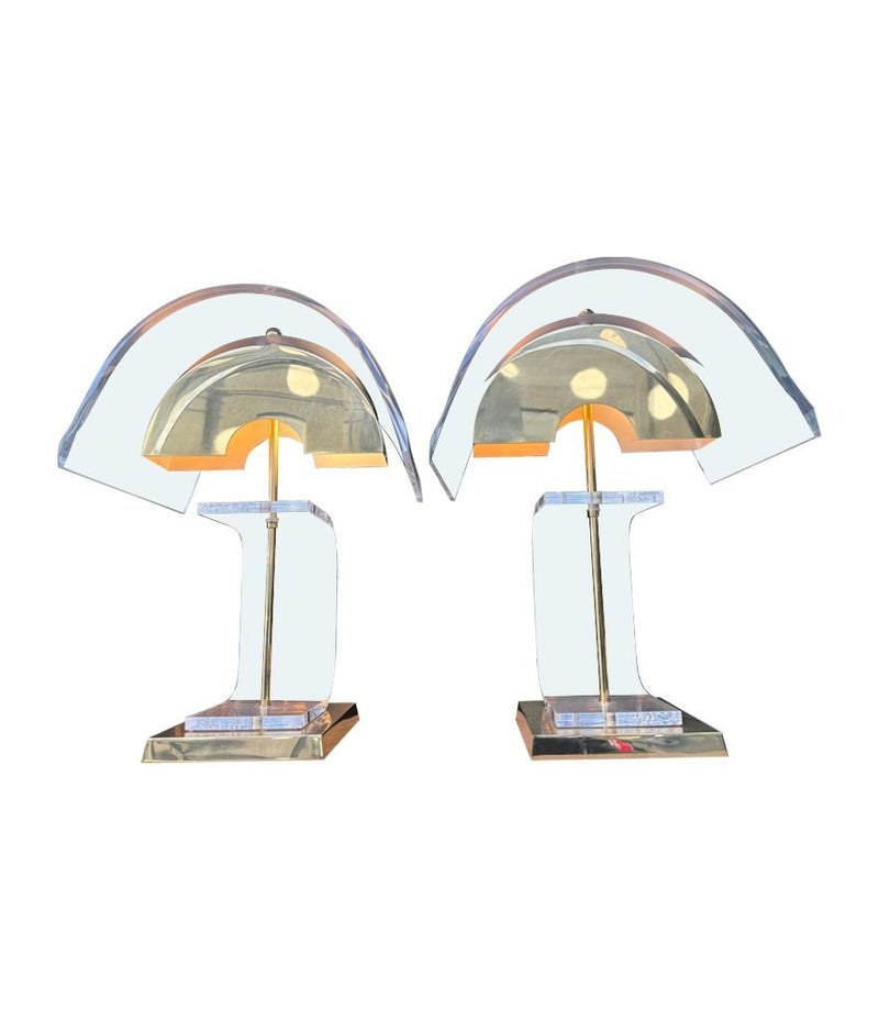 A large unusual pair of 1980s lucite and brass lamps with curved lucite shade and base