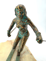 A large pair of bronze cast skiers by Curtis Jere mounted on onyx slabs