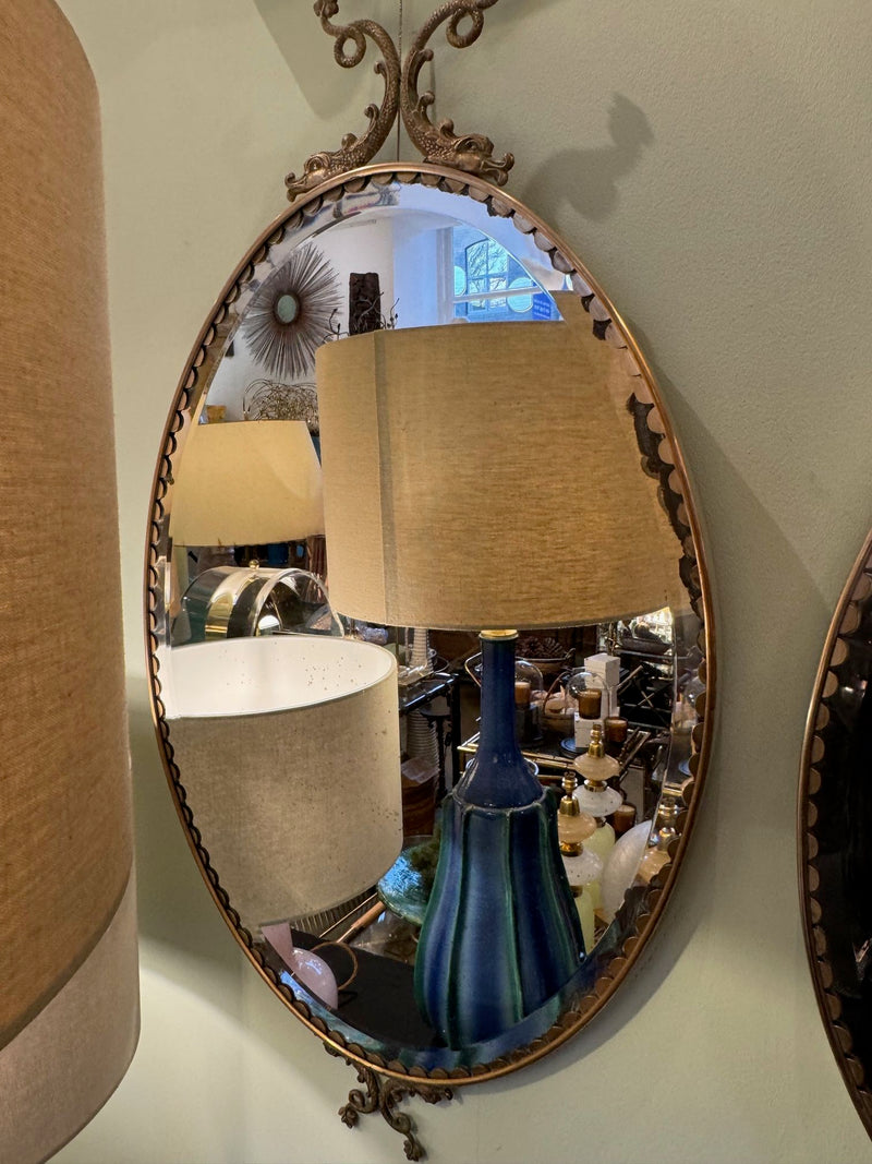 Mid century mirrors Italian oval with brass frame and dolphin detailing.