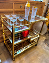 Mid century Romeo Rega Italian gilt metal bar trolley with smoked glass shelves