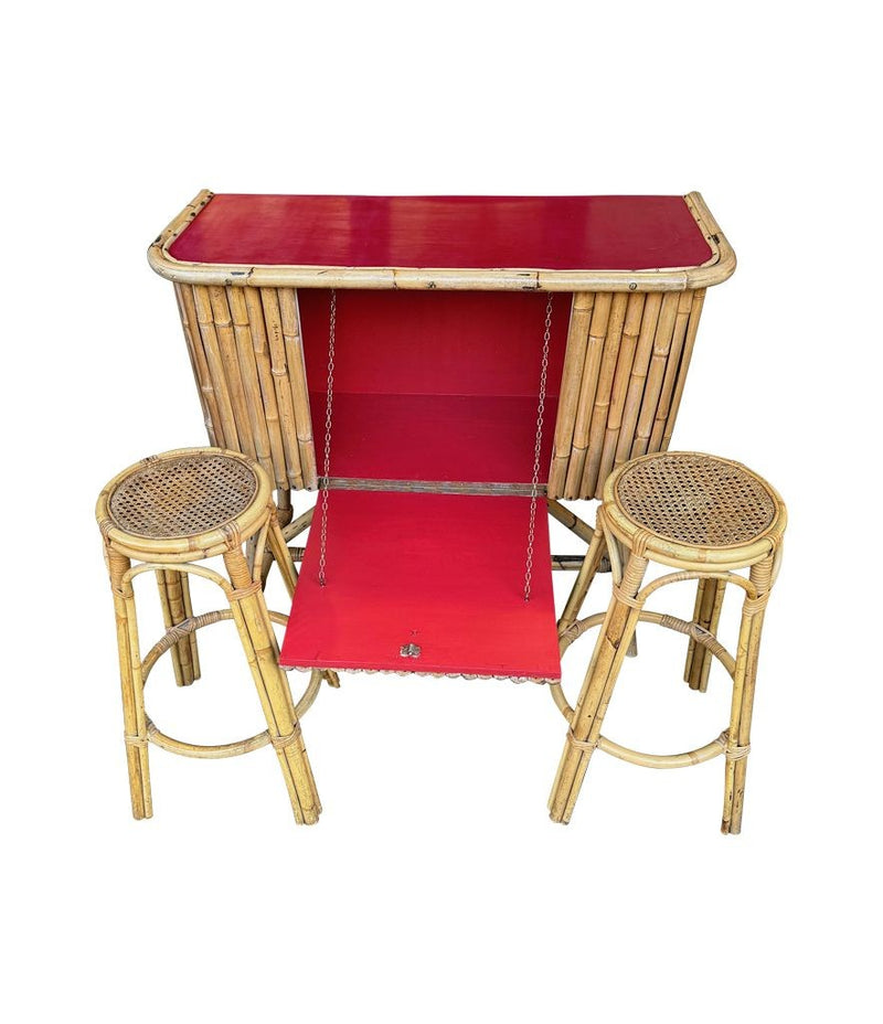 An Italian 1960s bamboo bar cabinet with red laminate top and two stools