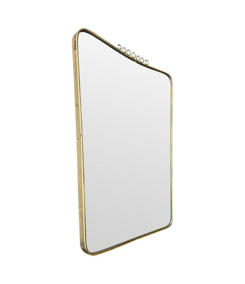 An original 1950s Italian brass framed mirror attributed to Gio Ponti with top brass squiggle detail. With original mirror plate and solid plate back.