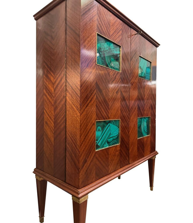 A wonderful 1950s two door bar cabinet by Poalo Buffa with faux malachite panels