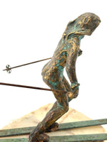 A large pair of bronze cast skiers by Curtis Jere mounted on onyx slabs