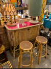 An Italian 1960s bamboo bar cabinet with red laminate top and two stools