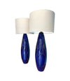 A pair of Italian 1980s large blue ceramic and brass lamps, rewired with with new fittings and linen shades