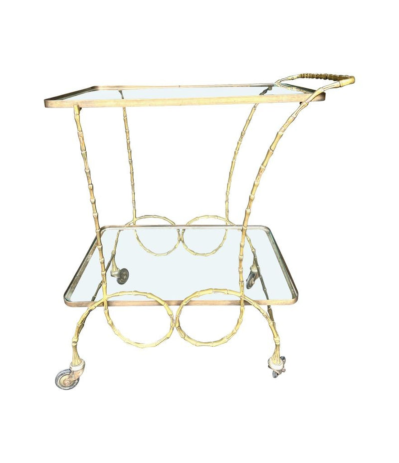 A pretty French 1950s solid brass faux bamboo bar trolley by Maison Baques with two glass shelves