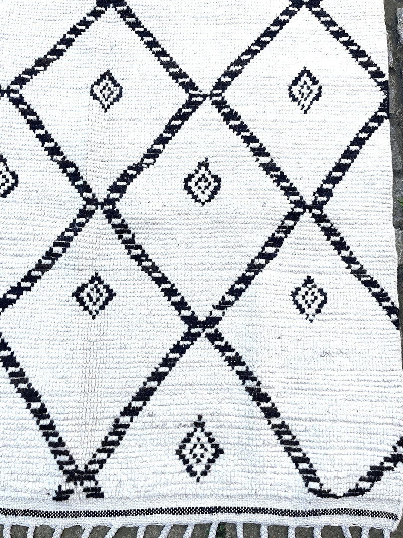 A vintage handwoven Moroccan berber rug, with tribal diamond and line pattern by the Beni Ouarian tribe