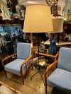 A 1950s French black lacquer and brass tripod floor lamp with glass centre table