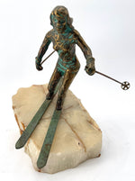 A large pair of bronze cast skiers by Curtis Jere mounted on onyx slabs