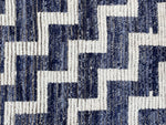 A handmade Morrocan Beni Ourain Berber rug with blue and white stepped design.