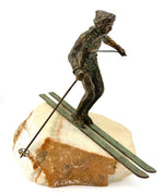 A large pair of bronze cast skiers by Curtis Jere mounted on onyx slabs