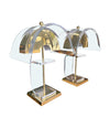 A large unusual pair of 1980s lucite and brass lamps with curved lucite shade and base