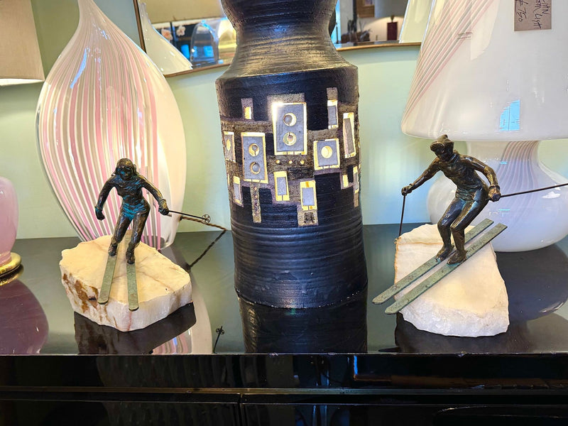 A large pair of bronze cast skiers by Curtis Jere mounted on onyx slabs