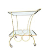 A pretty French 1950s solid brass faux bamboo bar trolley by Maison Baques with two glass shelves