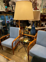 A 1950s French black lacquer and brass tripod floor lamp with glass centre table