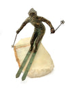 A large pair of bronze cast skiers by Curtis Jere mounted on onyx slabs