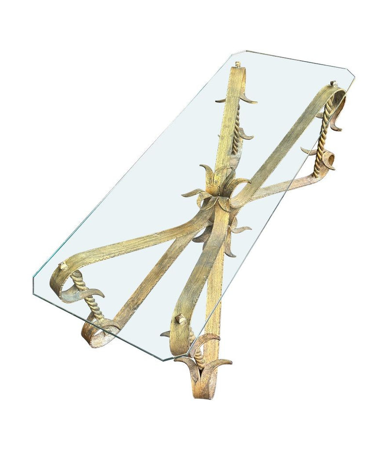 A Spanish 1950s gilt wrought iron coffee table with thick glass top