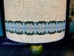 A large French 1960s green glazed ceramic lamp with original hessian shade