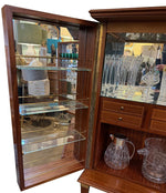 A wonderful 1950s two door bar cabinet by Poalo Buffa with faux malachite panels