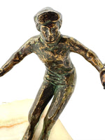 A large pair of bronze cast skiers by Curtis Jere mounted on onyx slabs