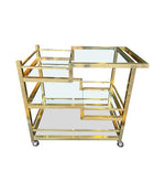 A 1970s Romeo Rega Italian bar trolley with multiple smoked glass shelves