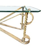 A Spanish 1950s gilt wrought iron coffee table with thick glass top