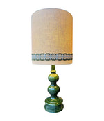 A large French 1960s green glazed ceramic lamp with original hessian shade