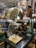 A large unusual pair of 1980s lucite and brass lamps with curved lucite shade and base