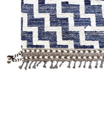 A handmade Morrocan Beni Ourain Berber rug with blue and white stepped design.