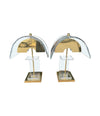 A large unusual pair of 1980s lucite and brass lamps with curved lucite shade and base