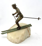 A large pair of bronze cast skiers by Curtis Jere mounted on onyx slabs