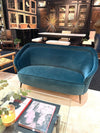 An original Italian 1950s two seater sofa with curved back, with brass and wooden feet