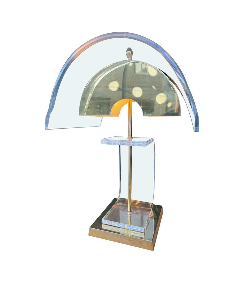 A large unusual pair of 1980s lucite and brass lamps with curved lucite shade and base