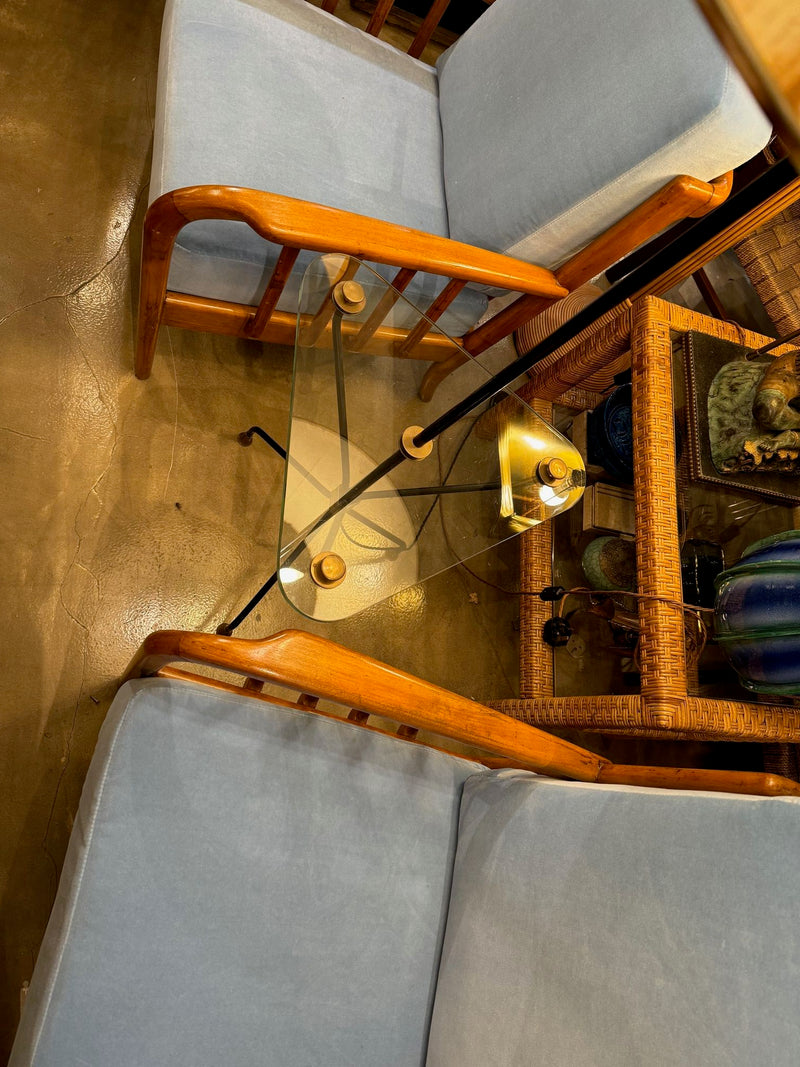 A 1950s French black lacquer and brass tripod floor lamp with glass centre table